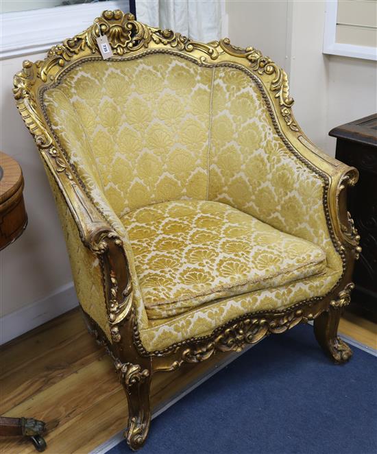 A pair of gilt armchairs